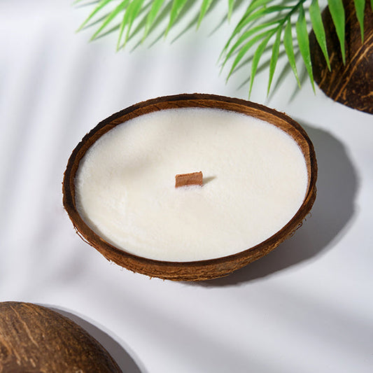 Candle in a coconut shell with a crackling wick.